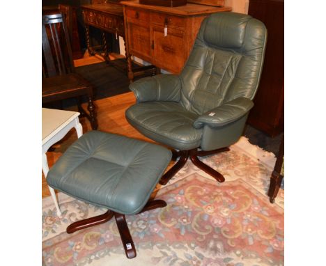 A green leather swivel armchair, raised on wood supports, 94cm high x 83cm wide, with matching stool (2)