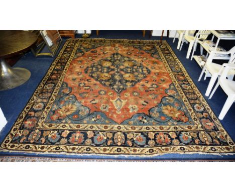 An antique Persian tabriz carpet, the central blue floral diamond over red ground with floral decoration, spandrels and tripl