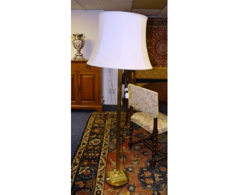 A gilt metal floor lamp with shade, in the Corinthian style, raised on circular base, converted, 163cm high