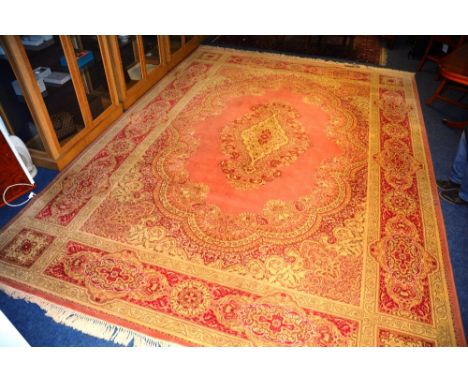 A super Keshan carpet, the central medallion over pink ground with floral spandrels and panelled border, 412 x 299cm