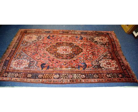 A fine Persian Qashqai carpet, the central medallion over red ground with floral decoration, spandrels and borders, 274 x 168