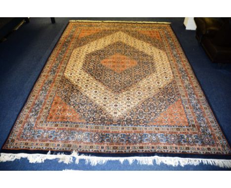 A Feraghan style carpet, the allover Herati design in diamond pattern, on orange, blue and cream ground with multiple borders