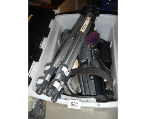 A camera tripod, camera etc.,