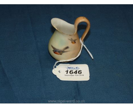 A small Royal Worcester pitcher with hand painted birds in flight, 2 1/2" tall