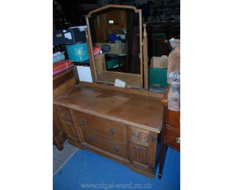A matching light Oak Dressing Chest with linen fold, fruiting vine and York rose style decoration, a pair of central drawers 