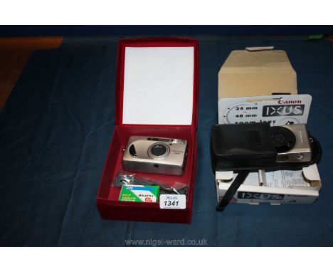 A boxed original Canon Ixus with leather case together with a Fujifilm Zoomdate 1000 35mm compact camera.
