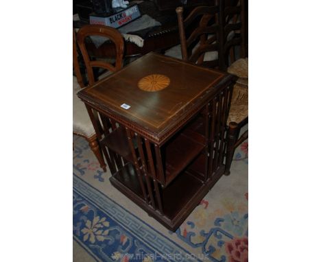 An early 20th c. Mahogany revolving Bookcase having light and dark wood stringing and shaded circle inlay to the centre, 19 3