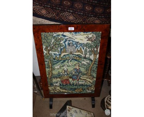 A large Firescreen with embroidered scene of shepherd, his wife and their sheep
