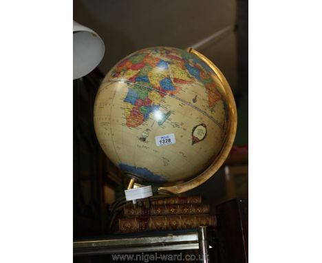 A globe table lamp standing on three books