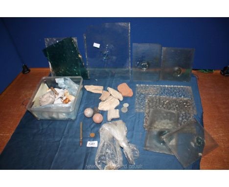 A quantity of clay pipe parts, oil lamp, bulls eye glass window panes, etc