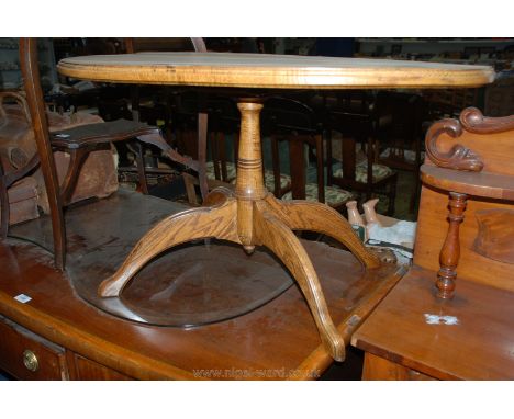 An oval light Oak Occasional Table on turned pillar with four splay feet, 36 1/4" x 21 1/2" x 20 1/2" high.