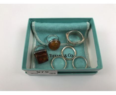 Two contemporary Baltic amber and white metal cocktail rings, together with a heavy white metal dress ring (stamped 925), and