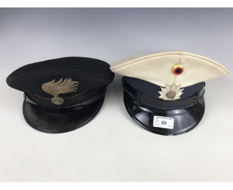 A post war German police cap together with an Italian police cap