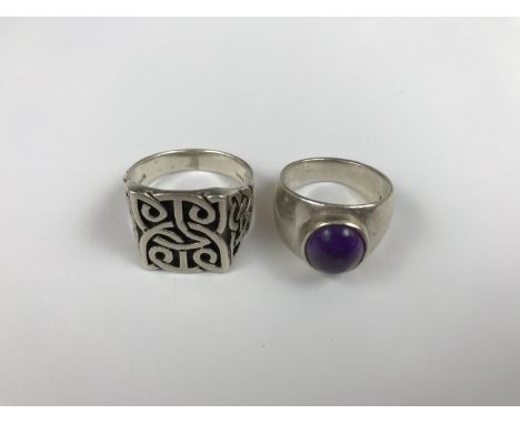 A heavy silver Celtic-strapwork finger ring, together with another silver ring set with an amethyst cabochon 