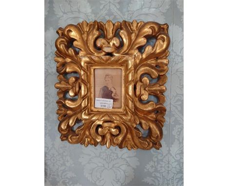 Pair of gold painted portrait frames of foliage design.
