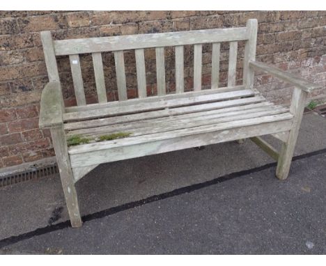 A WEATHERED TEAK GARDEN BENCH by R.A. Lister and Company, 128cm wide (some decay)
