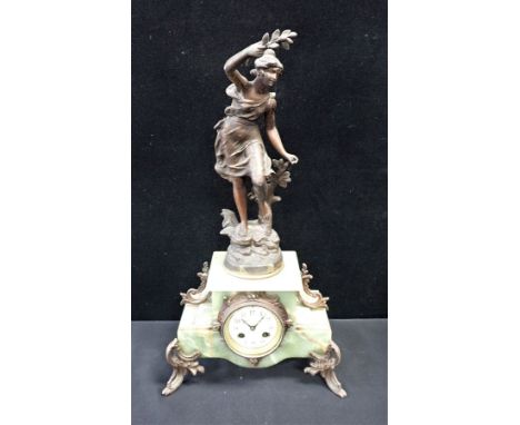 AN ONYX AND SPELTER FIGURAL CLOCK with presentation plaque, 1911, striking on a gong, 56cm high (a/f no key or pendulum)