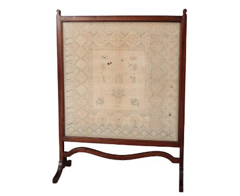 A MAHOGANY FIRESCREEN early 19th century, mounted with a period sampler, 95cm high x 71cm wide. Povenance: The Estate of The 