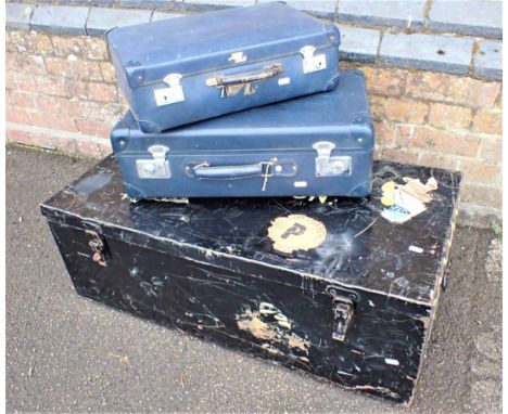 A MILITARY BLACK METAL UNIFORM TRUNK (dented) and two vintage blue compostition suitcases. Provenance: The Estate of the late