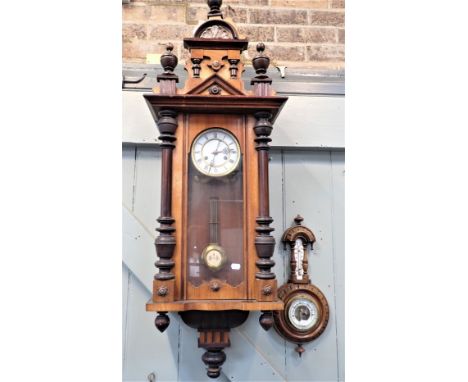 A VICTORIAN VIENNA STYLE WALL CLOCK striking on a gong, with turned and moulded decoration 110cm high (running), and an anero