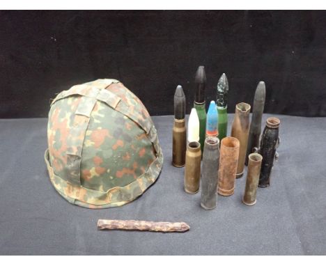 A RARE WWII FOOT MINE an army camouflage helmet and some mocked up shells