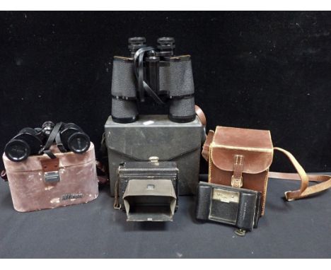A HOUGHTON BUTCHER ENSIGN FOLDING CAMERA with a Rollex Patent roll film back, a two binoculars, one by Nikon