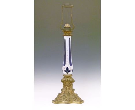 19th Century cast ormolu and glass table lamp, the slender baluster column with gilt highlighted blue and white overlay decor