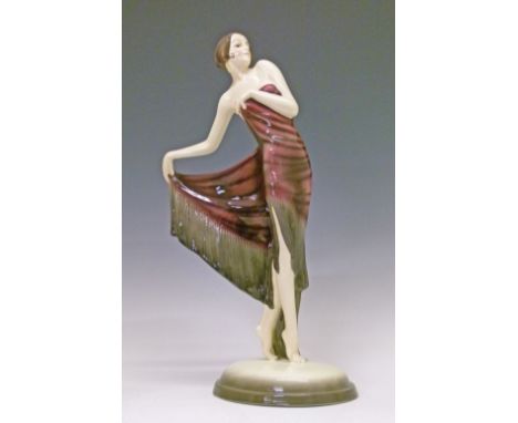 Goldscheider figure of a dancing girl, circa 1935, after Josef Lorenzl, wearing a black and pink tasselled dress, her hair cu