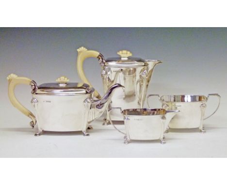 George VI silver Art Deco design four piece tea service, the teapot and hot water jug with carved ivory handles and knops, ea