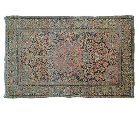 Persian rug decorated with a central medallion on a tight-knit foliate deep blue ground within multi borders, 216cm x 135cm  
