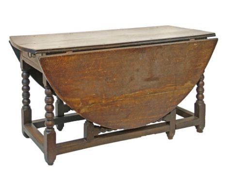 18th Century oak two flap oval gateleg dining table fitted two drawers and standing on bobbin turned supports united by stret