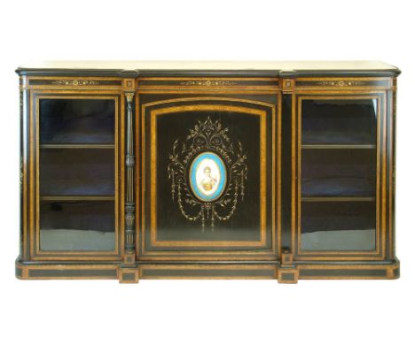 Victorian burr walnut banded ebonised credenza, the central cupboard door having an oval Sevres style porcelain panel depicti