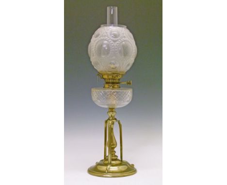 Late 19th/early 20th Century oil lamp having a clear cut glass reservoir, the Aesthetic School brass base having a central ba