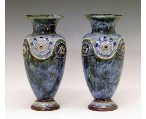 Pair of Doulton Lambeth stoneware vases, each having a band of stylised foliate decoration in relief on a mottled green and p