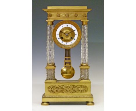 Early 19th Century French ormolu and cut glass portico clock, the circular dial with enamelled chapter ring and engraved deco