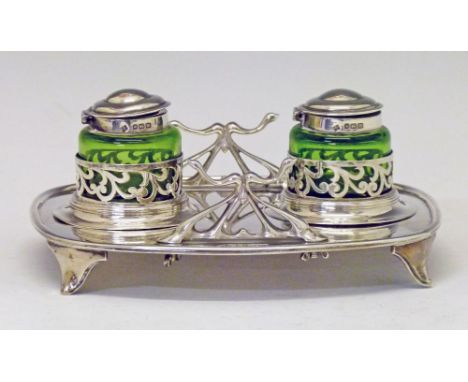 Edward VII silver inkstand of shaped rectangular form having two green glass inkwells, each within a circular pierced holder,