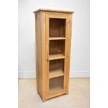 A modern light oak display cabinet, with single glazed door, height 184cm, width 70cm.
