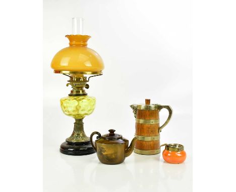 A brass oil lamp with yellow shade, an oak and brass mounted jug, a Royal Vistas Ware teapot and a Moorcroft ashtray (4).