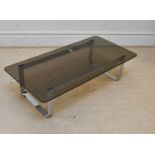 A vintage chrome framed coffee table with smoky glass top, length 120cm.