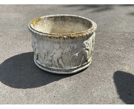 A modern reconstituted stone circular planter relief decorated with cherubs, diameter 61cm, height 40cm.