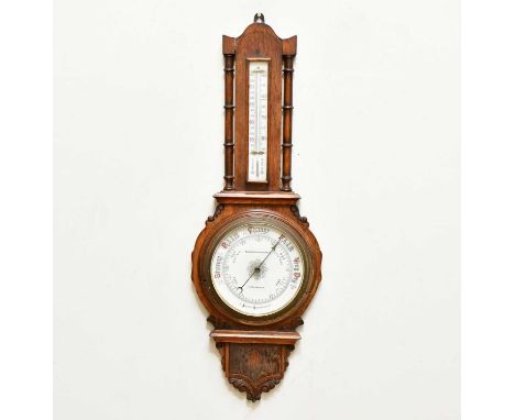 EDWARDS &amp; BROOKES, MACCLESFIELD; an oak carved aneroid barometer, length 80cm. 