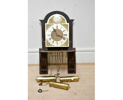 An eight day movement clock and face with brass dial and Roman numerals, inscribed 'Tempus Fugit' with associated carved oak 