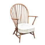 ERCOL; an elm spindle back arm chair, height 93cm.