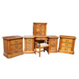 A good quality modern hardwood five piece bedroom suite comprising tall chest of five drawers, on