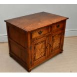 A reproduction oak and willow side cupboard with two drawers above two panelled cupboard doors, on
