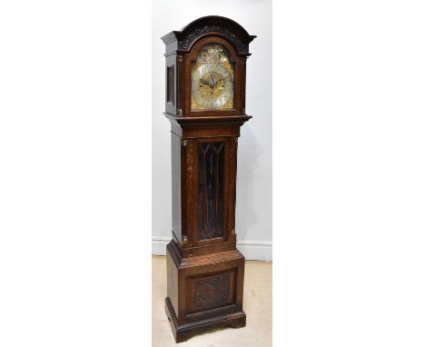 A late 19th century eight day longcase clock, the brass face with chased and applied floral decoration, with silvered chapter