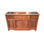 A modern hardwood sideboard with sliding marble inset panels to the top above an arrangement of