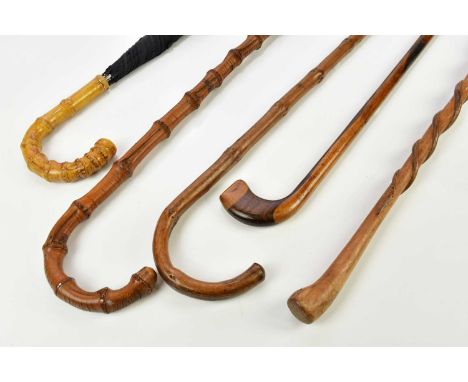 An early 20th century lignum vitae walking stick, with golf club type head, length 88cm, with a walking cane carved with two 