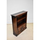 TITCHMARSH & GOODWIN; an oak freestanding bookcase, with pair of panel doors to base, width 84cm.
