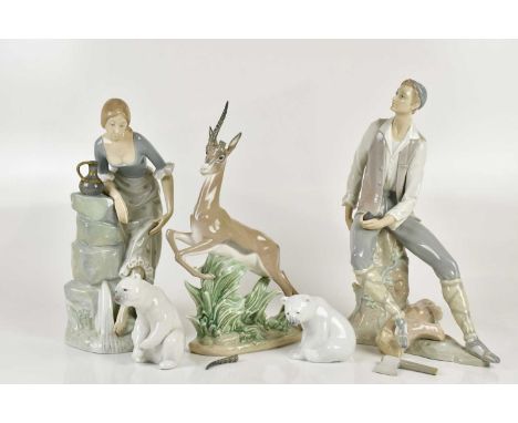 LLADRÓ; a large figure of a woodcutter, height 35cm, also a gazelle, height 33cm, a pair of small polar bears and a large Nao